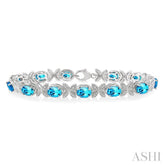 7x5 MM Oval Cut Blue Topaz and 1/10 Ctw Round Cut Diamond Semi-Precious Bracelet in Sterling Silver