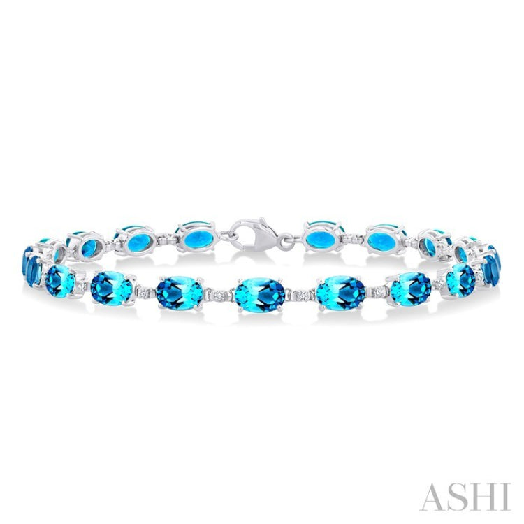 6X4 MM Oval Cut Blue Topaz and 1/6 Ctw Round Cut Diamond Semi-Precious Tennis Bracelet in 10K White Gold