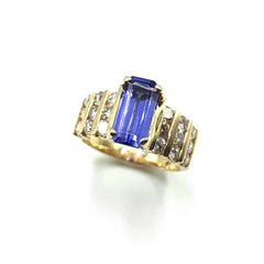 APPRAISED $4800 - 1 Emerald Cut shaped Tanzanite (10.85x5.4x4.42) Center and 18 Round Brilliant Shaped Diamonds - T - 1.20ct in a Channel Set 