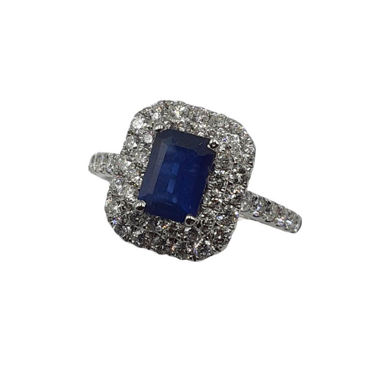 APPRAISED $2000 - 18kt White Gold Ring with 1 Emerald Cut Sapphire (6.75x4.7mm) Surrounded by 48 Round Brilliant Diamonds - T. - .64ct in a Double Halo and Along Sides 