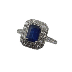 APPRAISED $2000 - 18kt White Gold Ring with 1 Emerald Cut Sapphire (6.75x4.7mm) Surrounded by 48 Round Brilliant Diamonds - T. - .64ct in a Double Halo and Along Sides 