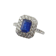 APPRAISED $2000 - 18kt White Gold Ring with 1 Emerald Cut Sapphire (6.75x4.7mm) Surrounded by 48 Round Brilliant Diamonds - T. - .64ct in a Double Halo and Along Sides