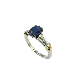 APPRAISED $4100 - Platinum Band with 18kt Gold Accents with 1 Oval-Shaped Sapphire Center (9x7) with 2 Tapered Baguette Diamonds - T. - .38ct 