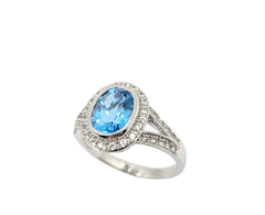 APPRAISED $1050- 14KT White Gold Ring with a Oval Blue Topaz Center Stone surrounded by Round White Topaz in a Halo & Split Shank Design